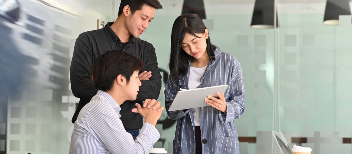 Team startup business discussion with tablet computer.